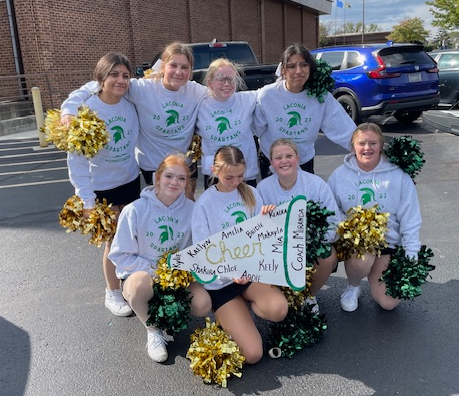 spartan cheer team posing in a group at the homecoming parade
